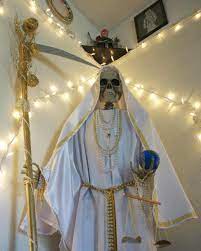 A devotee of santa muerte blows smoke at a figure of the saint at her shrine in tepito, mexico city. Growing Devotion To Santa Muerte In U S And Abroad