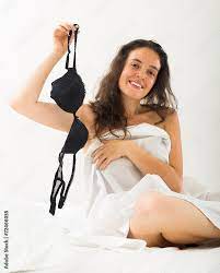 Brunette undressing in bedroom Stock Photo | Adobe Stock