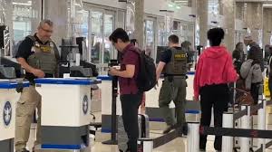 ICE agents take a more active role in airport security, but long lines persist ahead of the weekend traveler rush