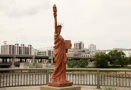 Time Machine The Story Behind The Mini Statue Of Liberty In Downtown Cedar Rapids The Gazette The statue of liberty is depicted as a woman dressed in flowing robes, she holds a torch over head with her right hand, and carries a tablet with her left hand. story behind the mini statue of liberty