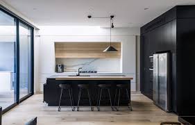 In the expansive, monochromatic chef's kitchen black and gold combine to create a sleek profile in this streamlined, modern kitchen. 20 Modern Black And White Kitchens That Used Wood Home Design Lover White Wood Kitchens Modern Kitchen Design Minimalist Kitchen