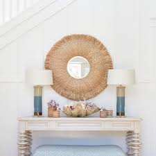 This chic beach house entry design began with the creation of our custom  console. We love the fun spindle legs! Natural elements and a soft color  pallet welcome you in. #coastaldecor #coastal #