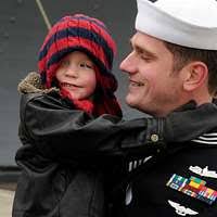 Master-at-Arms 1st Class Laymoun Ferguson lights a candle during a National  Holocaust Remembrance Day ceremony at Commander, Fleet Activities Sasebo.