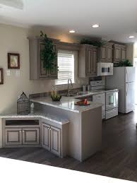 I can, however, create a beautiful kitchen using a little elbow grease and creativity to update mobile home kitchen cabinets, just like the following homeowners did. Bahia Kitchen With Stone Gray Glazed Cabinets And Spring Carnival Counters Factory Expo Home Centers