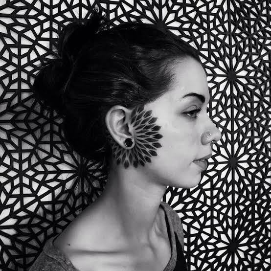 Dotwork mandala tattoo surrounding the right ear.