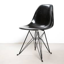 These chairs boast a plastic seat and wooden legs with metal supports. Eames Fiberglass Shell Side Chair By Herman Miller 149639