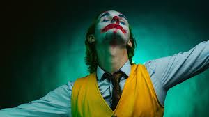 Joker 2019 wallpapers, joaquin phoenix. Joaquin Phoenix Joker Wearing Blue Shirt And Yellow Vise Coat With Green And Black Background Hd Joker Wallpaper A Wallpaper Wallpapers Printed
