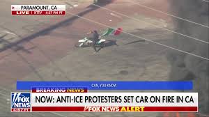 Fox News - Man with a Mexican flag circles a burning car...