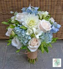 Gorgeous yellow and blue bridal bouquet ideas to rock your world! Pretty Blue And White Just Picked Bouquet Featuring Ivory Dahlia Roses Blue Hydrangea Blu Blue Wedding Bouquet Blue Wedding Flowers White Wedding Bouquets