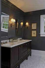 A dark wicker basket and a traditional rug add texture and softness to the whole, contrasting with the sometimes cold look of marble. Dark Gray Bathroom Walls With The Dark Wood Vanity And Fixtures And White Accents Dark Gray Bathroom Dark Wood Vanity Bathroom Gray Bathroom Walls