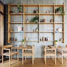 Try dining chairs in complementing colours, a bold shade on the walls and hang artwork on the walls. Restaurants Dezeen