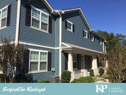 A Stunning Example Of Norman Rockwell Vinyl Siding In A Bold Blue Color Brick Siding House Siding Exterior House Paint Color Combinations