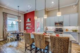 One wall is curry silk hunter douglas over glass doors that usually is up and allows bright light. Beautiful Red Accent Wall In This Nice Open Kitchen Stock Photo Picture And Royalty Free Image Image 145043116