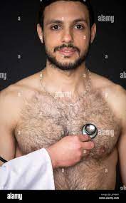 doctor with a stethoscope listening to a shirtless patients heartbeat Stock  Photo - Alamy