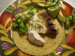 Basa fish fillets are pan fried and served on a bed of rice with a spicy tomatillo sauce. Basa Fish Fillets Foodie Joanie