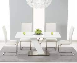 White glass rectangular dining table and 4 chairs, with description: Mark Harris Portland White High Gloss Dining Table And 4 Malibu Ivory Chairs Cfs Furniture Uk