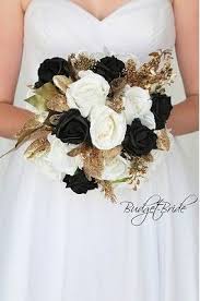 Black And Gold Flowers Gold And Black Wedding Flower Brides Bouquet With Black And Ivory Roses Gold Foliage Black Wedding Themes Black And White Wedding Theme Black Wedding Flowers