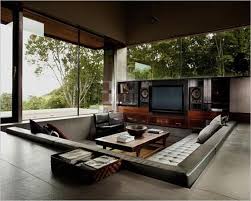 An outdoor sunken fire pit with gravel around and a deck that doubles as a bench around the pit is a cool modern solution. Cozy Living Room Designs With Fireplaces Defined By Sunken And Raised Floor Areas