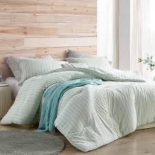 The comforter features a blush and grey paintbrush stroke abstract print, on a soft white cotton base fabric, creating a charming contemporary look. Serenity Mint Stripe Oversized Comforter 100 Cotton Twin