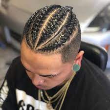Man With Black Hair Black T Shirt Gold Necklaces Man Bun Braids Blurred Background Mens Braids Hairstyles Hair Styles Mens Hairstyles