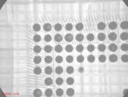 X-ray and cross-section views of void formation in filled via-in-pad under BGA ball