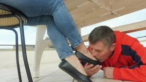 Femdom in tight jeans and ballerinas bossing around her foot slave