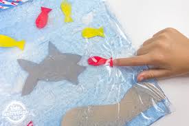 Gelatin squish bags are the perfect sensory bag for babies because the contents are edible and safe. Your Little Ones Will Love This Feed The Shark Sensory Bag