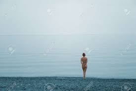Lonely Naked Girl On The Beach Of Quite Sea Stock Photo, Picture And  Royalty Free Image. Image 1564978.