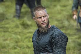 The ragnar lothbrok hairstyle, made possible by actor travis fimmel, can be best characterized as a braided variation of a top knot or man ponytail with shaved sides. Hd Wallpaper Men S Black Tops Vikings The Vikings Travis Fimmel Ragnar Lothbrok Wallpaper Flare