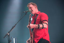 Josh homme is seen on stage moments before lashing out at the snappercredit: Queens Of The Stone Age S Josh Homme Releases A Cover Of Silent Night Diy