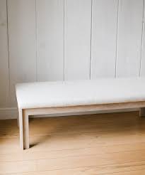 Incorporating a backless and armless design, this gorgeous rectangular bench is upholstered in a brown linen fabric. Upholstered Bench Textured Natural Linen Jenni Kayne