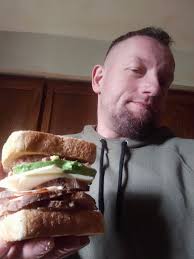 Turkey and avocado bacon sandwich with chips