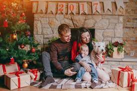 Family Sitting In Front Of The Fireplace With Their Baby And Their Dog And A Chri Christmas Family Photoshoot Christmas Photoshoot Kids Christmas Family Photos