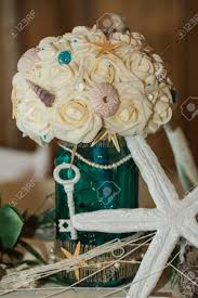 It is a wonderful and delicious place to bring in your beach theme. Cute Fun Handmade Beach Themed Ocean Wedding Reception Decorations Party Centerpiece With Floral Bouquet Starfish And Key Stock Photo Picture And Royalty Free Image Image 81857947
