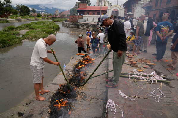 Nepal flood deaths: symbolic funerals held for those feared lost as some missing tourists make contact with authorities