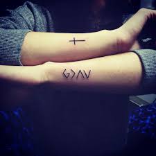 The phrase does not represent a particular bible verse but communicates the greatness of god. He Is Greater Than I Tattoo With Cross