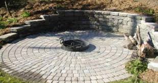 Using a level, make sure the bricks are relatively even all the way around. Great Idea Fire Pit Area Built Into Hillside Retaining Wall Backyard Fire Sloped Backyard Backyard
