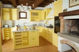 Yellow Kitchen Balanced With White Walls And Rustic Beamed Ceiling Very Nice Fireplace In Kitchen Iron Yellow Kitchen Cabinets Yellow Cabinets Yellow Kitchen