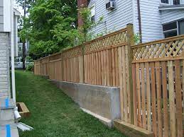 Wood Semi Private Fence Alternating Board With Lattice Topper On Retaining Wall Fence Design Backyard Fences Private Fence Ideas