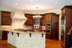 The main kitchen cabinets uses black solid surface and has white vertical wood planks for its backsplash. Kitchen Stone Island Designs Ksa G Com