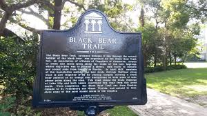 There are tennis courts surrounded by. Black Bear Trail History Sign At Lake Lily History Sign Lake Black Bear