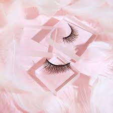 Download A Pair Of False Eyelashes On A Pink Background | Wallpapers.com