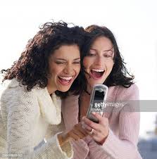 Two Women Friends Using Mobile Phone Laughing Closeup High-Res Stock Photo  - Getty Images