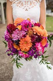 Inspired by colors of fiery red and orange and using few pieces of her work as wedding decor this is truly a wedding that reflects the personality of the bride and groom. Purple Orange Fall Wedding In The Smoky Mountains Ronda Eric The Pink Bride Orange Purple Wedding Orange And Pink Wedding Orange Wedding Flowers