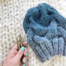 Crescent shaped shawl knit in bulky yarn with a wide lace border on a garter stitch body. 8 Free Cable Hat Knitting Patterns Blog Nobleknits