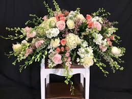 Casket or coffin sprays are large arrangements of flowers that are approximately 4 feet long and are elegantly draped on the casket. Soft Pink Casket Spray In Waldorf Md Country Florist