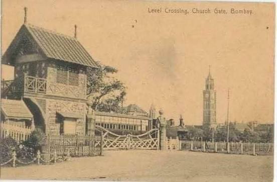 If not for the tower in the background, one would probably never guess the building Unbelievable to see a level crossing gate at Churchgate station and a steam engine hauled train passing