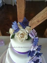 Wedding cake with flowers and butterflies. Stunning Homemade Purple Butterfly Wedding Cake