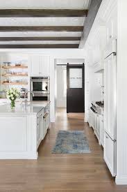 The striking dark grey finish looks both luxurious and contemporary and works wonderfully with the white worktops. Blue And Gray Rug In White Shaker Kitchen Transitional Kitchen