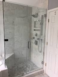 The glass shower door dresses up the bathroom. Marble Shower With Hexagon Floor And Frameless Shower Door Frameless Shower Doors Shower Doors Bathroom Remodel Shower